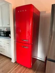 Smeg 50'S Retro Style 24" Bottom Freezer Refrigerator / Red Left Hinge Used. Price: $2600.00.